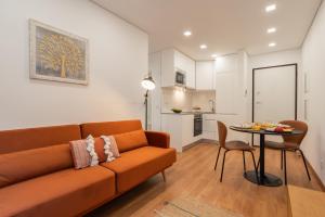 a living room with a couch and a table at HostWise - Stylish & Cozy Flat in Matosinhos