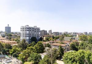 a cityscape of a city with tall buildings and trees at Appartement Marina Bay A13 in Nairobi