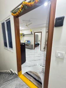 a room with a mirror and a living room at Elevated Escape Penthouse in Kondapur near AMB mall in Kondapur