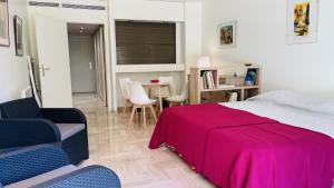 a bedroom with a bed and a table and chairs at Résidence Gray d'Albion Studio ROU503 in Cannes