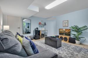 a living room with a couch and a flat screen tv at 1 BR Suite w Fenced Backyard - Parking! in Tucker +12 photos