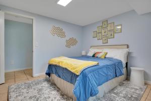 a bedroom with a bed and a blue wall at 1 BR Suite w Fenced Backyard - Parking! in Tucker