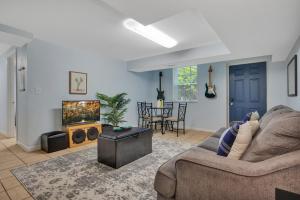 a living room with a couch and a tv at 1 BR Suite w Fenced Backyard - Parking! in Tucker