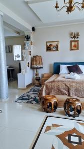 a bedroom with a bed and a lamp and a rug at Apartament GOLD in Timişoara