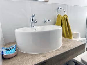 a bathroom with a white sink on a counter at Mantu Apartment in Cusco +36 photos