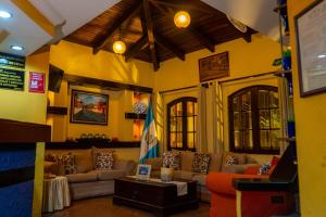 a living room with couches and a table at Hotel Villa Española in Guatemala