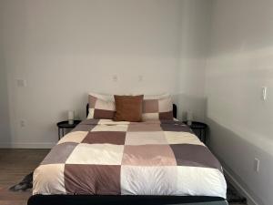 a bedroom with a large bed with two end tables at Santa Monica Bright Studio with stunning view in Los Angeles