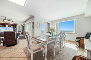 a dining room with a table and chairs at Beachfront Bliss! 1800 sq ft Spacious 3BR Sleeps 12 - Oceans 9D in Gulf Shores