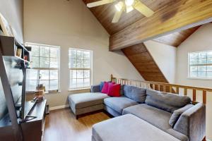 a living room with a couch and a tv at Welcoming Tahoe-Donner Cabin in Truckee