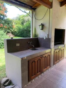 an outdoor kitchen with a sink and a counter at Naturaleza Pura Casa La Caldera in Salta