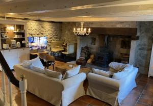 a living room with two couches and a fireplace at La Maison d'Edouard Spa Chauffé Privé prés du Lac in Lanobre
