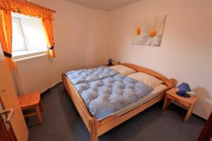 a bedroom with a bed with a blue mattress at "Ferienhof Alte Mühle" M 2 in Bannesdorf
