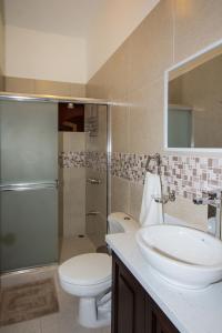 a bathroom with a sink and a toilet and a shower at Apartotel Don Luis in Bajo de las Labores