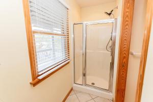 a shower stall in a bathroom with a window at Oceanside, Close to the Beach, Ocean and Sound Views! -O6, Summer House in Duck +36 photos
