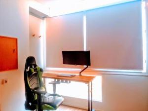a room with a desk with a monitor and a chair at Loft PLAYA -60m- & TRABAJO -online- in Almería +21 photos