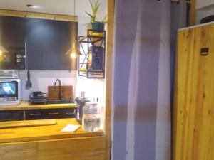 a kitchen with a counter top with a microwave at Loft PLAYA -60m- & TRABAJO -online- in Almería