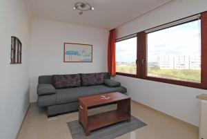 a living room with a couch and a table at Ferienwohnung Thordsen 2 in Burgtiefe auf Fehmarn 