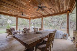 a dining room with a large wooden table and chairs at Hill Country Escape Hot Tub Pet Friendly in Dripping Springs