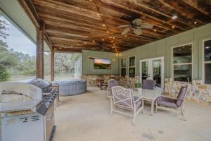 a covered patio with a table and chairs and a couch at Hill Country Escape Hot Tub Pet Friendly in Dripping Springs