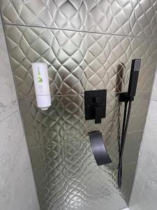 a bathroom with a soap dispenser on a wall at Style Central Victoria in Bucharest +69 photos