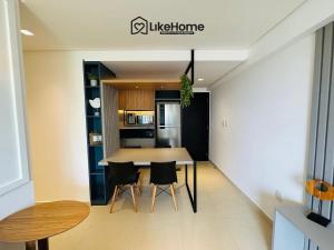 a kitchen with a table and chairs in a room at Park Del Prado - Intermares in Ilha da Restinga