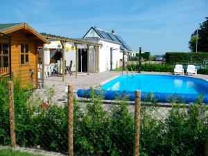 a swimming pool in the backyard of a house at Ferienhof Jahn - Appartment in Westfehmarn