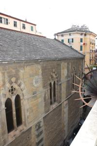 an old brick building with a clock on it at Le Diel rooms & breakfast in Genova