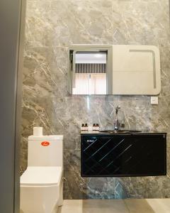 a bathroom with a sink and a mirror at Olive Garden Baku Hotel in Baku +55 photos