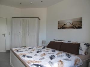 a bed in a white room with at Ferienwohnung Kath in Marienleuchte +9 photos
