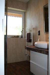 a bathroom with a sink and a window at Ferienwohnung Kath in Marienleuchte