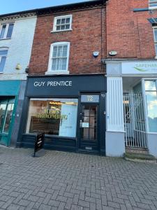 a store front of a brick building on a street at 2 bedroom central apartment in Hereford