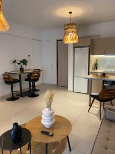 a kitchen and living room with a vase on a table at NEW 2BD Aprt with Shared Rooftop Pool B3 in Athens