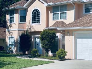 a large pink house with a garage at Beautiful Pool Home near the I95 Exit 284 in Palm Coast