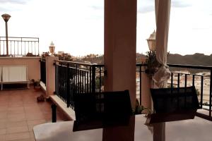 a balcony with two chairs and a view of the water at La Terraza in Águilas