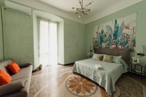 a bedroom with a bed and a couch at Le Diel rooms & breakfast in Genova
