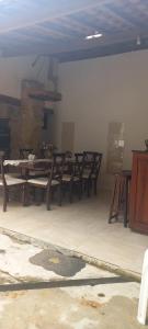 a dining room with wooden tables and chairs at Casa Paraty in Paraty +1 photo