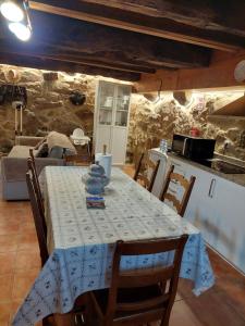 a dining room table with a blue and white table cloth at Cantinho de Tourêm in Tourém +40 photos