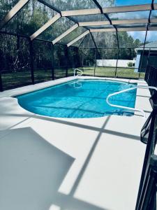 an overhead view of a swimming pool under a pergola at Beautiful Pool Home near the I95 Exit 284 in Palm Coast