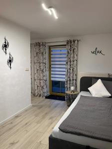 a bedroom with a bed and a large window at Ferienwohnung Köppl in Lam