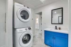 a laundry room with a washing machine and a sink at Balcony and Sunset Views Coastal Port Bolivar Gem in Port Bolivar