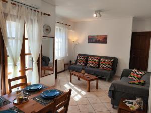 a living room with a couch and a table at Evgenia's House in Kala Nera