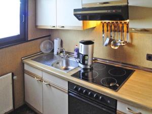 a kitchen with a sink and a coffee maker on the counter at Ferienhaus, Burhave in Burhave