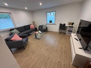 a living room with a couch and a tv at Ferienhaus Rehblick Schwerin in Schwerin