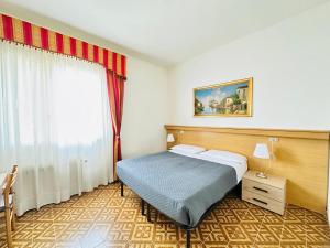 Postel nebo postele na pokoji v ubytování Hotel Tito