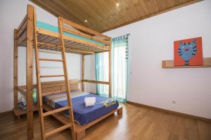 a bedroom with a bunk bed and a ladder at Casa Oliveira in Loulé +36 photos