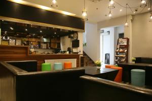 a restaurant with a bar with a table and chairs at Shanghai Fish Inn Bund in Shanghai