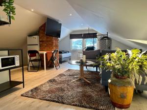 a living room with a couch and a table at Arctic Loft in Skjervøy