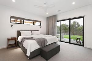 a bedroom with a large bed and a large window at Dalhousie Birregurra Modern Country Escape in Whoorel