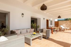 a living room with a couch and a table at New! Villa Can Vinyes in San Antonio