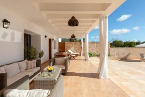 a living room with a couch and a table at New! Villa Can Vinyes in San Antonio